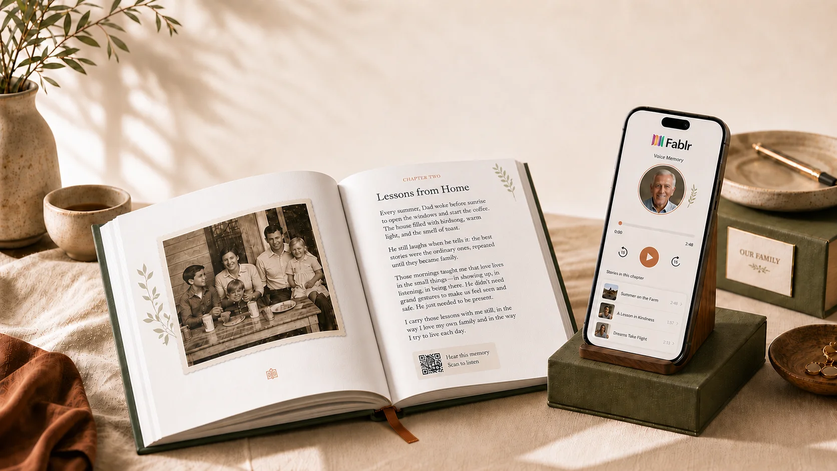 An open Fablr hardcover beside a phone on a stand playing the chapter in the storyteller's own voice