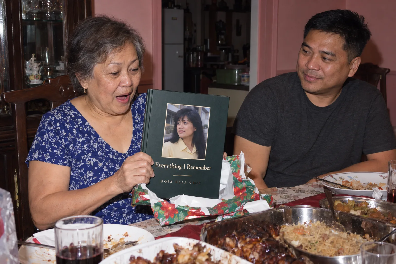 A mother at a holiday dinner table unwraps her Fablr hardcover as her adult son watches.